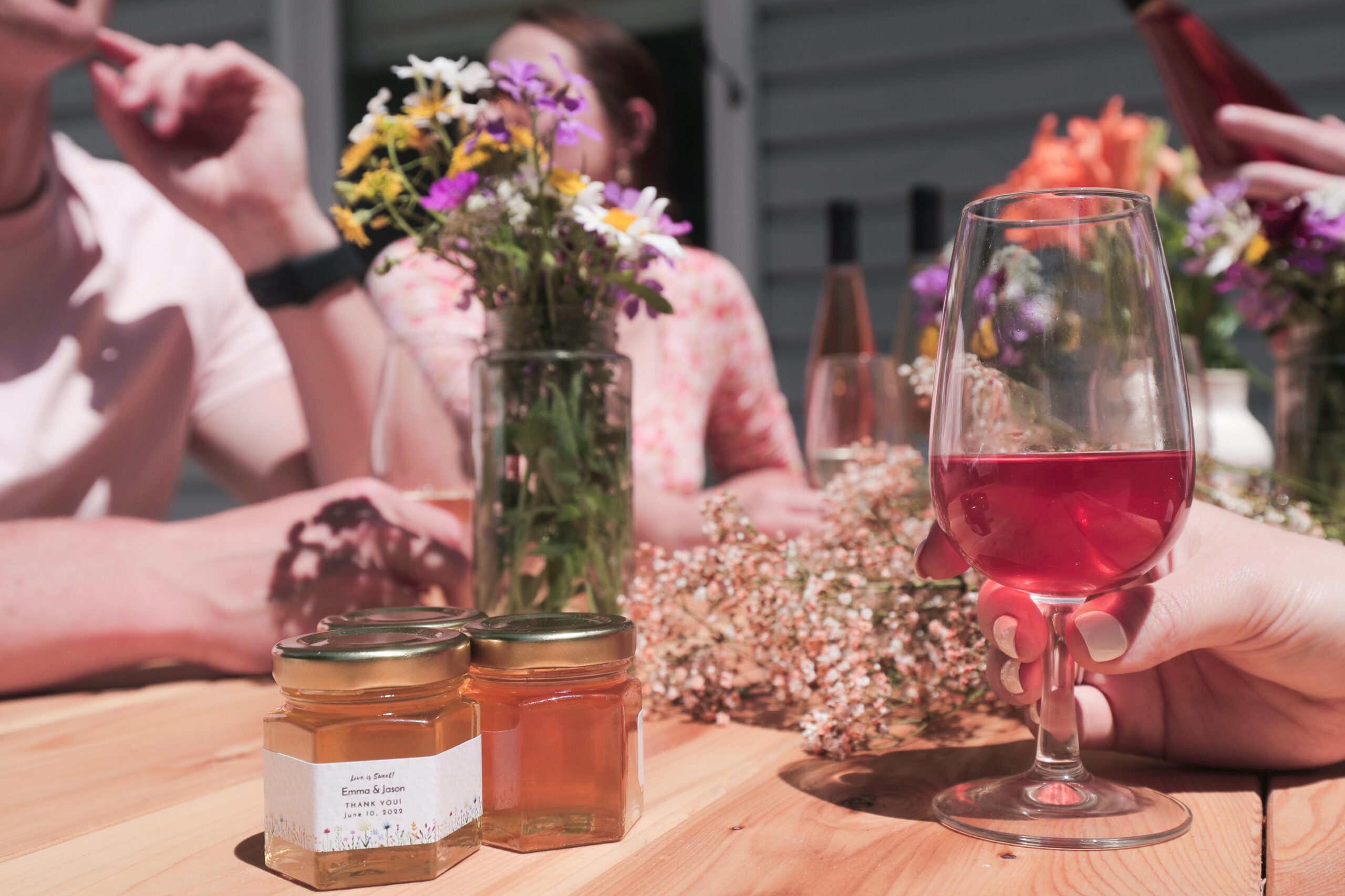 Sunny summer day. Table set with flowers, Ontario honey and glasses of various mead, sparkling honey wine. Rural Route Tour Company tour.